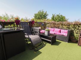 An outdoor seating area with a sofa and table at 33 Pendle View Clitheroe
