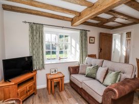 A living room with a sofa and television at Holly Cottage in Whitby