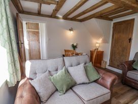 A living room with a sofa and dining table at Holly Cottage in Whitby