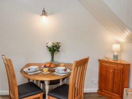 A dining area with a table and chairs at Holly Cottage in Whitby