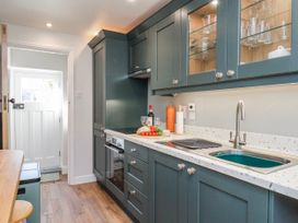 A kitchen with a sink and cabinets at Holly Cottage in Whitby