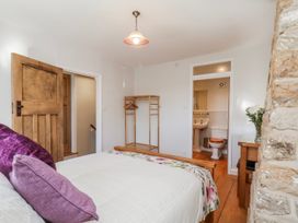 A bedroom with a bed and connected bathroom at Holly Cottage in Whitby