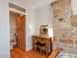 A bathroom with a toilet and vanity at Holly Cottage in Whitby