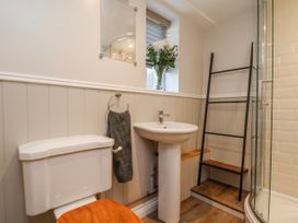 A bathroom with a toilet, sink, and shower at Holly Cottage in Whitby