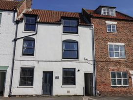 A house with multiple windows and a door at Marina Side in Whitby