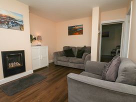 A living room with a sofa and fireplace at Marina Side in Whitby