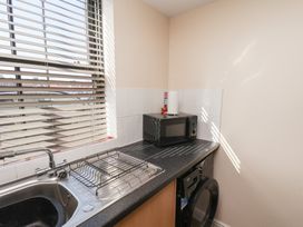 A kitchen with a sink and microwave at Marina Side in Whitby
