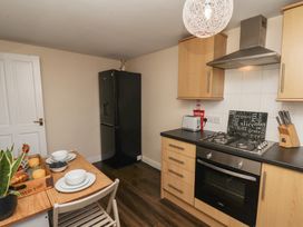 A kitchen with a table and chairs at Marina Side in Whitby