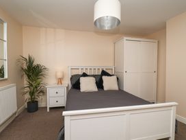 A bedroom with a bed and wardrobe at Marina Side in Whitby