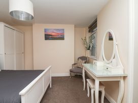 A bedroom with a bed and wardrobe at Marina Side in Whitby