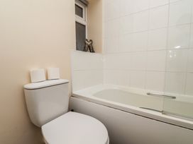 A bathroom with a toilet and bath tub at Marina Side in Whitby