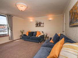 A living room with sofas and wall art at Marina House in Whitby