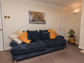A living room with a sofa and wall art at Marina House in Whitby