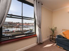 A living room with a view of a harbor at Marina House in Whitby