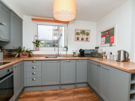 A kitchen with cabinets and appliances at Marina House in Whitby
