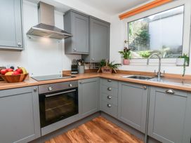 A kitchen with cabinets and appliances at Marina House in Whitby