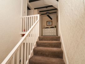 A staircase with a dresser in the hallway at Marina House in Whitby