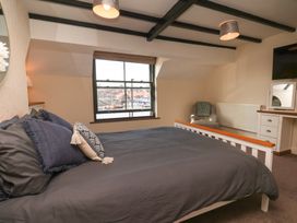 A bedroom with a bed and desk at Marina House in Whitby