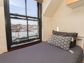 A bedroom with a view of the marina at Marina House in Whitby