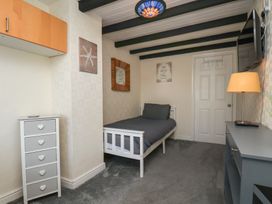 A bedroom with a bed and a television at Marina House in Whitby