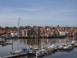 A marina with boats and buildings at Marina House in Whitby