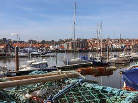 A harbor with boats and buildings at Marina House in Whitby