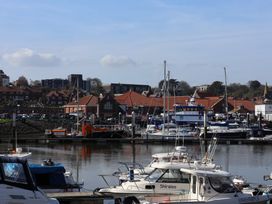 A marina with boats and buildings at Marina House in Whitby