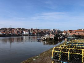 A view of a river with boats and buildings alongside at Marina House in Whitby