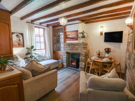 A living room with a sofa and dining table at Bishop's Cottage in Whitby