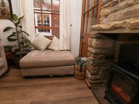 A living room with a couch and window at Bishop's Cottage in Whitby