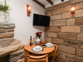 A dining area with a table and chairs at Bishop's Cottage in Whitby