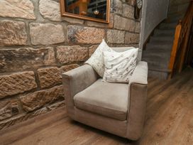An armchair with cushions in a hallway at Bishop's Cottage in Whitby