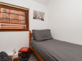 A bedroom with a bed and window at Bishop's Cottage in Whitby