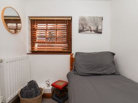 A bedroom with a bed and window at Bishop's Cottage in Whitby