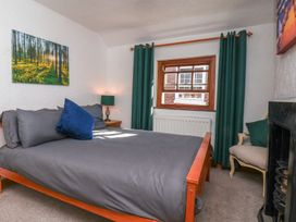 A bedroom with a bed and window at Bishop's Cottage in Whitby