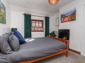 A bedroom with a bed and window at Bishop's Cottage in Whitby