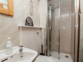 A bathroom featuring a sink, toilet, and shower at Bishop's Cottage in Whitby