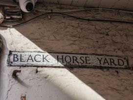 A sign reading BLACK HORSE YARD on a wall in Whitby