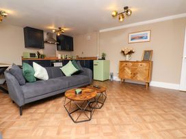 A living room with a sofa and coffee table at G's Loft in Whitby