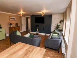 A living room with sofas and a table at G's Loft in Whitby