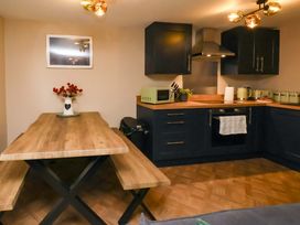 A kitchen with a table and benches at G's Loft in Whitby