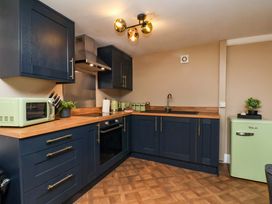 A kitchen with a sink and appliances at G's Loft in Whitby