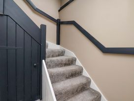 A staircase with carpet and a door at G's Loft in Whitby