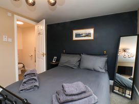 A bedroom with a bed and towels at G's Loft in Whitby