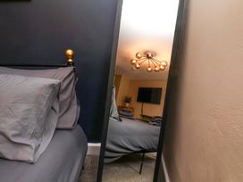 A bedroom with a bed and television at G's Loft in Whitby