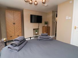 A bedroom with a bed and wardrobe at G's Loft in Whitby