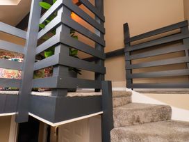 Stairs leading to a loft with railing and plant at G's Loft in Whitby
