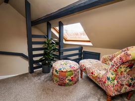 A snug area with a chair and ottoman at G's Loft in Whitby