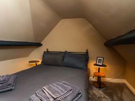 A bedroom with a bed and bedside tables at G's Loft in Whitby