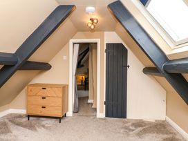 An attic with drawers and a door at G's Loft in Whitby